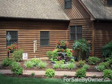 Stone Tiered Water Fountain & Flowers
						:
						New healthy shrubs & landscaping...Water fountain..Inviting sidewalk.
