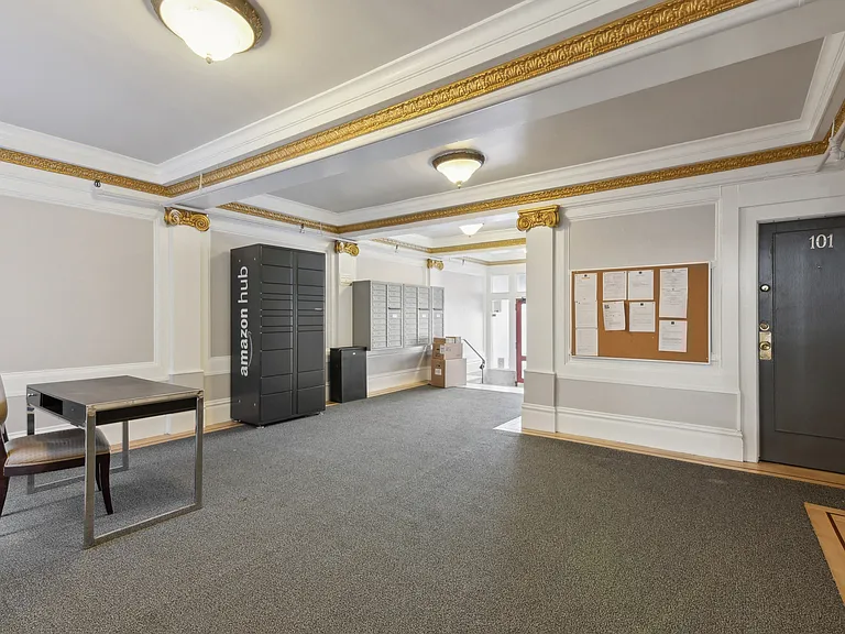 Lobby with a parcel and mail locker, anAmazon Hub Locker and front desk table