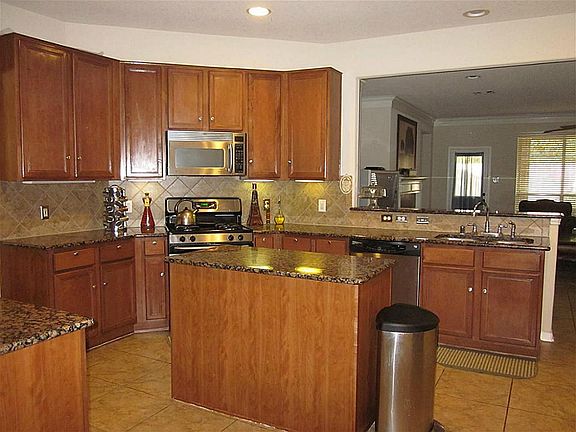 Notice the stainless steel applicancesincluding handy built-in microwave and energy efficient gas cooking!