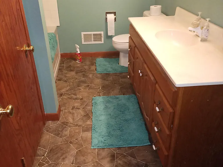 Private bath with whirlpool tub / shower and plenty of storage.