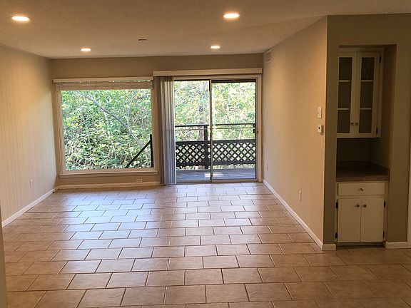 First Floor Living Area with cabinet nook, 6'x6' picture window and sliding glass door to first floor deck.