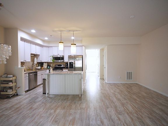 Foyer and kitchen. Half bathroom on the right side of foyer.