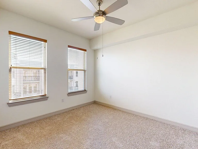 Griffis Uptown apartment bedroom with carpet floor.