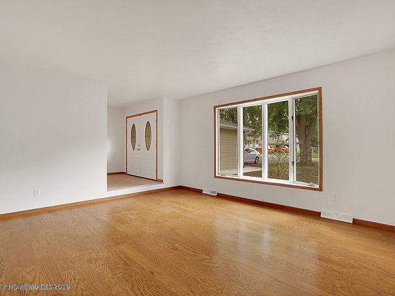 Living room has new engineered hardwood flooring.  Large bay window allows lots of light in this room.
