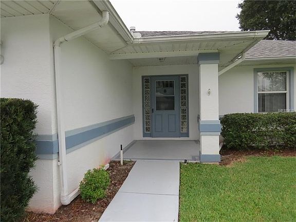 Nice covered porch with gutters and down spouts to help keep your guest dry during the occasional rains.  Home as 25 year warranty paint.