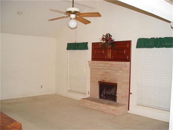 Den/Family Room with Brick Fireplace and vaulted ceiling.