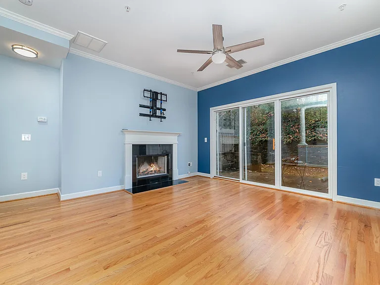 Great room with ceiling fan and patio access