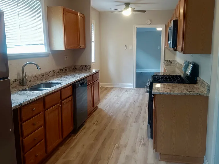 kitchen with new appliances and granite countertops. 26.5x8
