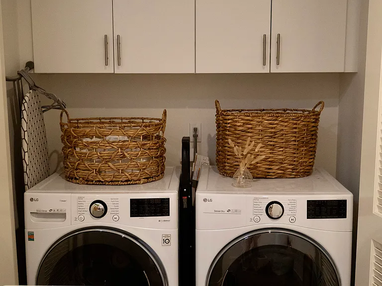 Laundry Room: A dedicated and functional space equipped with convenient upper cabinets for extra storage.