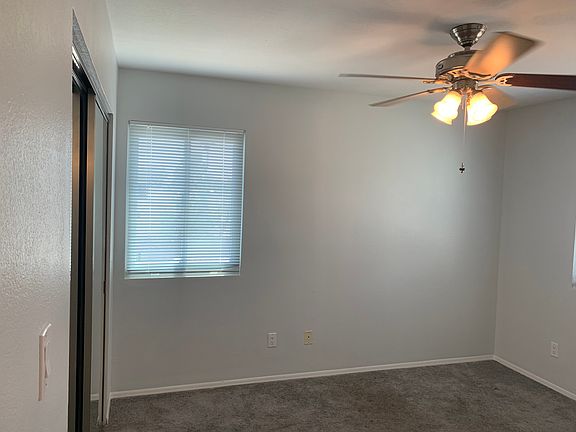 Master bedroom which includes mirrored closet doors; two windows; ceiling fan