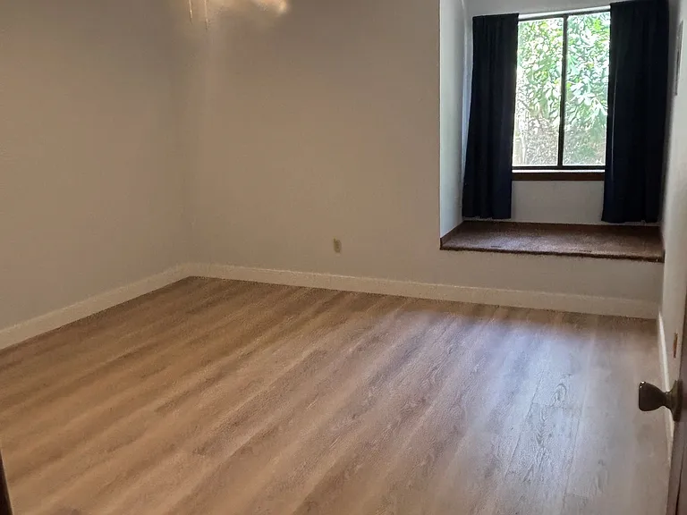 Master bedroom with ceiling fan, storage, 2 closets (one a walk-in) with view to private patio