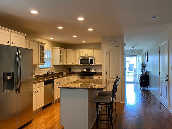 Kitchen with granite countertop and stainless steel appliances.