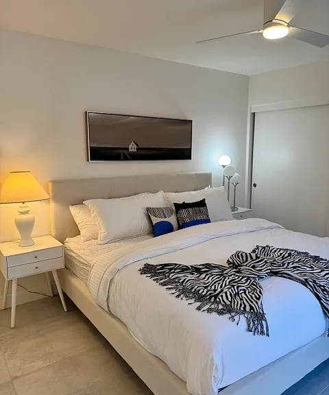 Guest room with Queen Bed and slider out to courtyard.