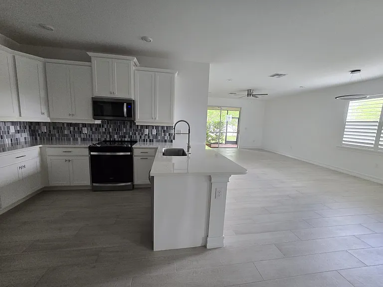 Open concept design perfectly unites the living room and kitchen into one, light-filled space.