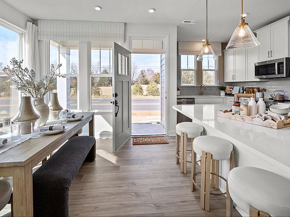 The Rochester Plan by DRB homes modern kitchen cozy dining area in Charlotte, NC.
