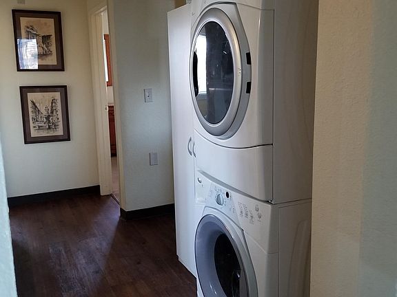 Washer/Dryer stack up and utility cabinet in hallway
