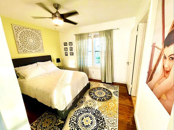 2nd bedroom with sliding closet and view of backyard