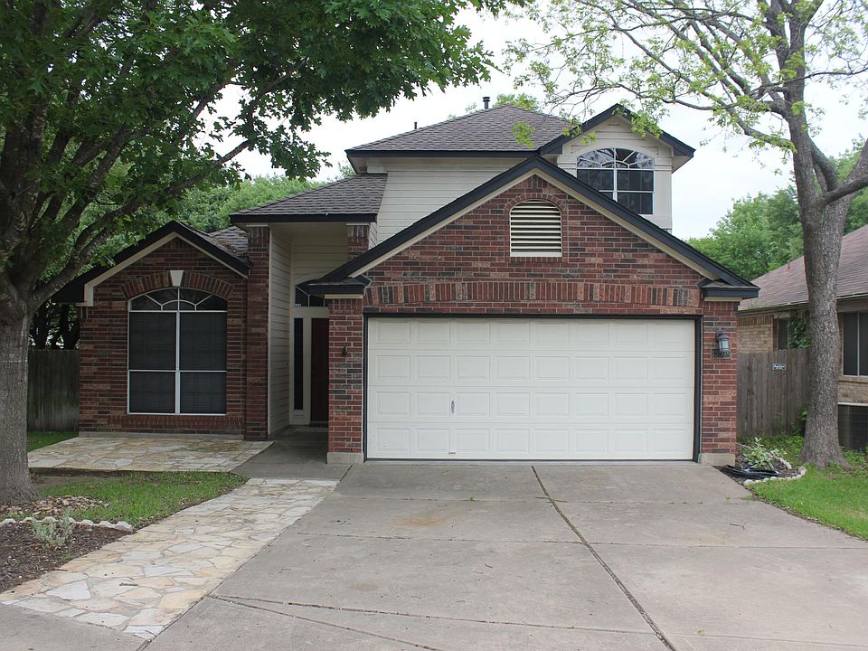 Beautiful shaded entry with red brick and flagstone patio and walkup.