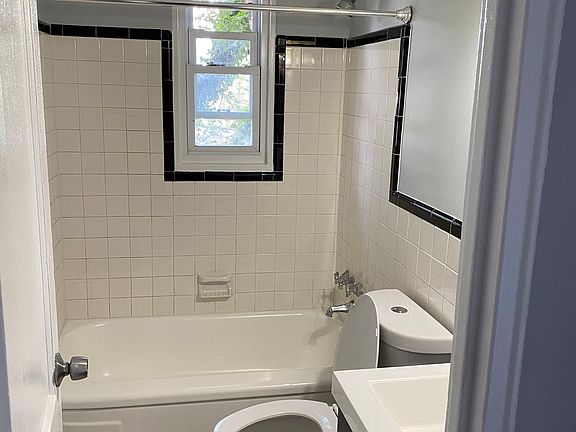 Renovated bathroom with brand new vanity and toilet.