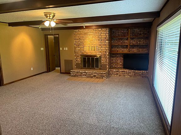 Den with fire place and TV