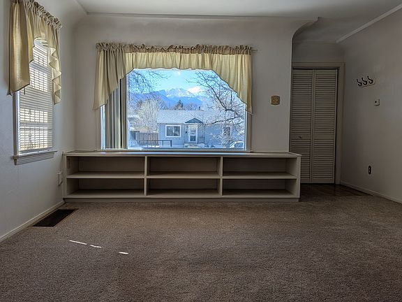The living room as seen from the kitchen offers a view of Pikes Peak.