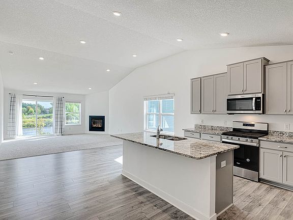 Kitchen with solid surface countertop, SS Appliances, vaulted ceilings and a nice sized Island