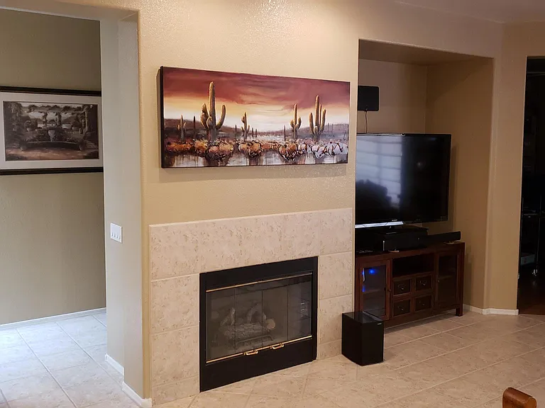 Entrance to hallway, fire place, and great room