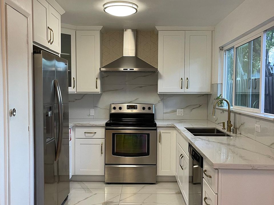 Newly renovated Kitchen with quartz counter top, porcelain tiles made in Spain, stainless steel dishwasher, refrigerator, and induction stove, pantry for storage