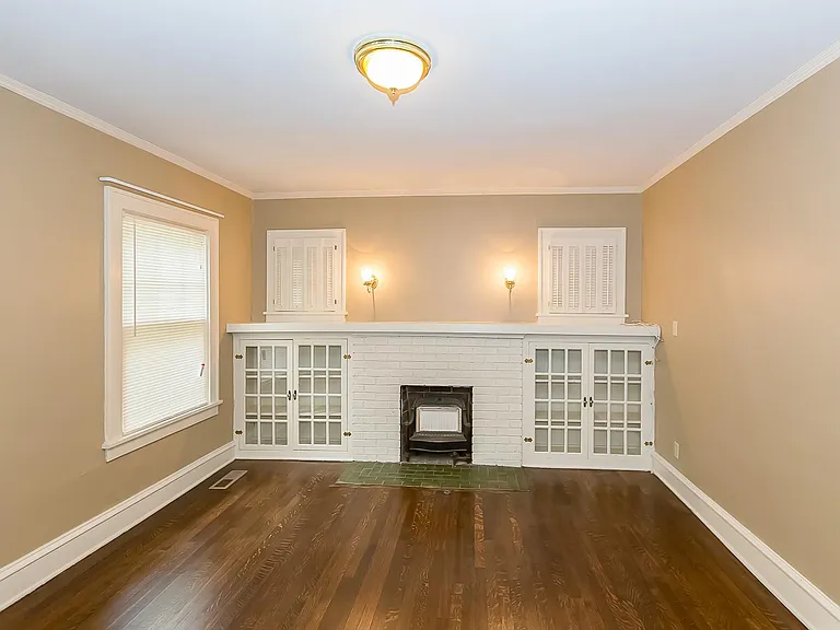 The Large Living room has Refinished Hardwood Floors .
