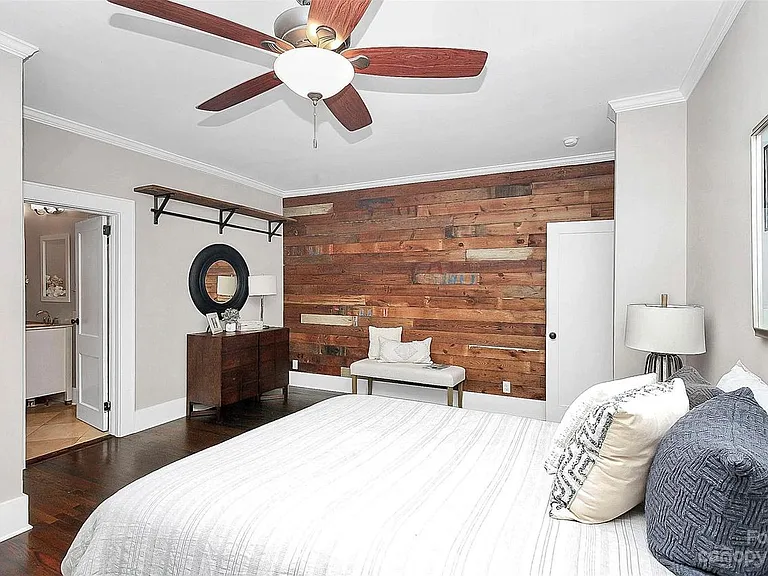massive master bedroom with shiplap accent wall