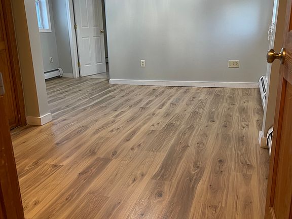 View as you enter into the apartment. Living room with new flooring.