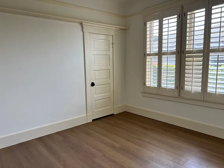 Secondary Bedroom - new LVT flooring, plantation shutters.