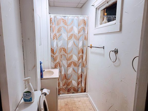 Bathroom with vanity and standing shower.