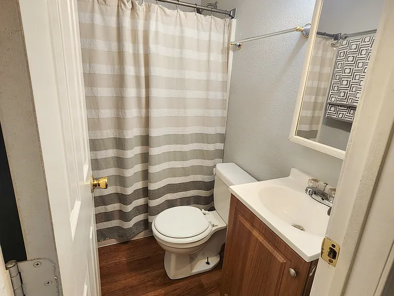 Hallway bathroom with linen closet behind door
