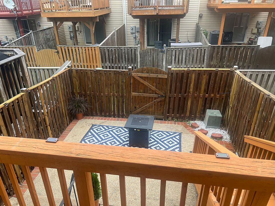 Backyard.Small deck and patio with an entrance to the basement