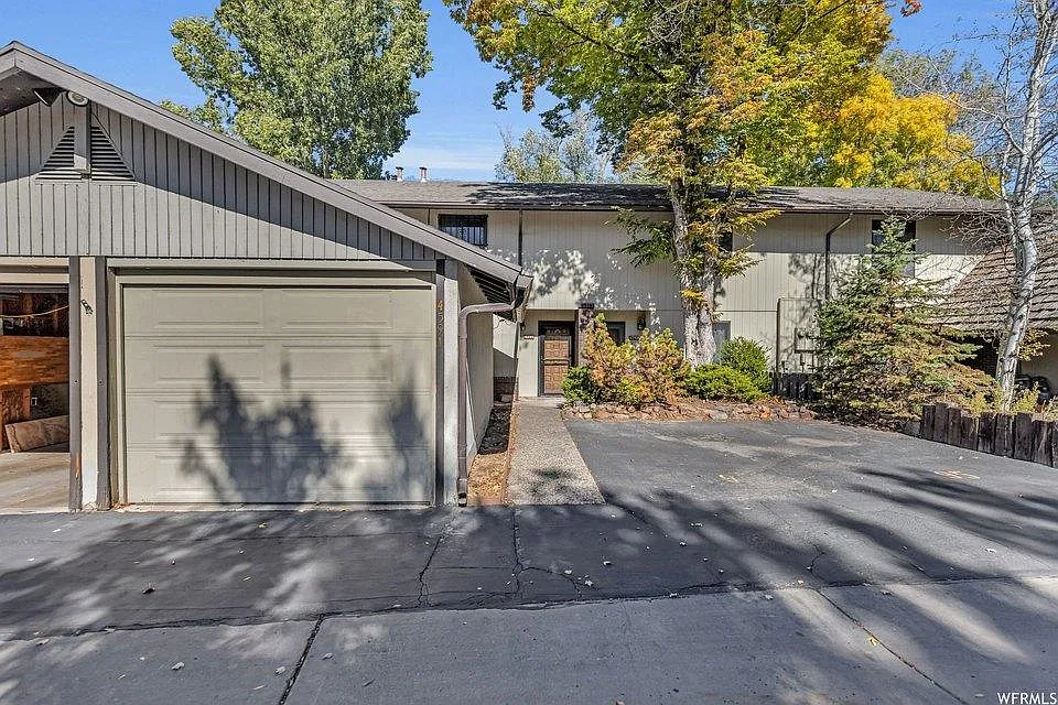 Front entry with one-car garage and unit-assigned parking space - 4591 S Woodduck Ln