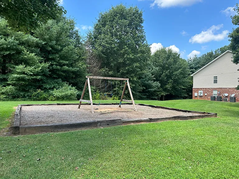 Grassy Area and Swingset with 1905 Bldg. in Background