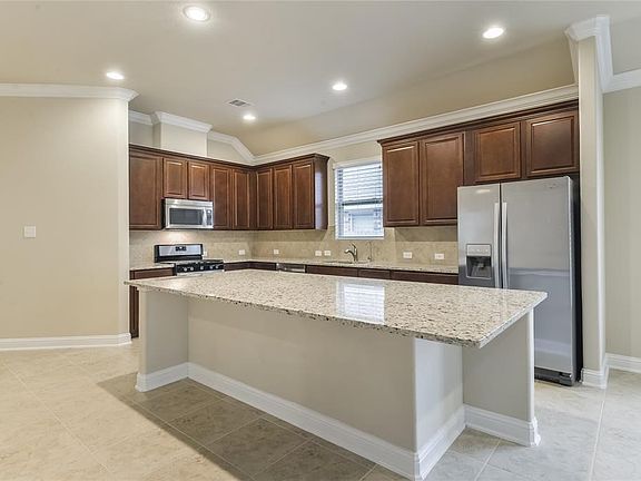 Gourmet kitchen with tons of space for prep and bar stools.