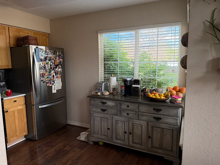 Kitchen with new quartz countertops, tile backsplash, sink and microwave. Large stainless steel fridge. Technically is the size of an "eat-in" kitchen (we chose to use a coffee bar in this area instead)