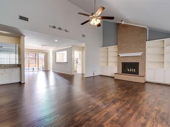 There are nice high ceilings, newly installed laminate wood floors, built-in shelves and cabinets, gas log fireplace and a wet bar in the living room.