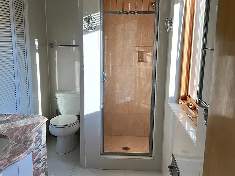 master bathroom with custom made marble base sink cabinet, shower, white porcelain tile