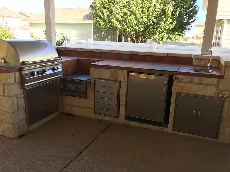 Outdoor Kitchen Featuring BBQ, Burner, Refrigerator, & More