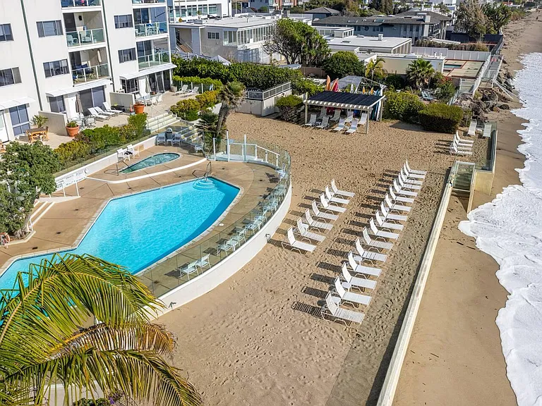 Seamless beach access awaits, a gateway to sun-kissed shores just steps away.