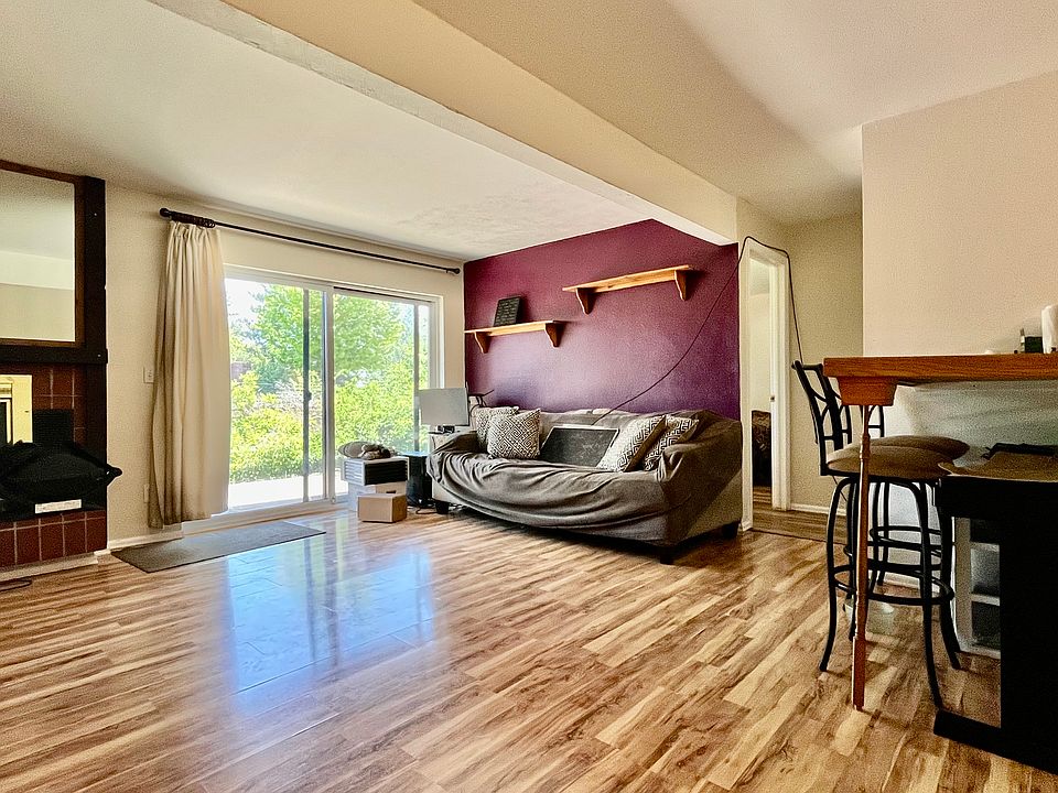 Living room with large eat-in bar/table off of kitchen.