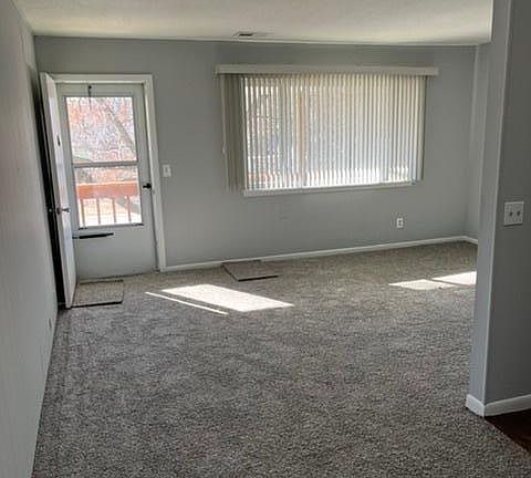Front door view with plenty of natural light in living room.
