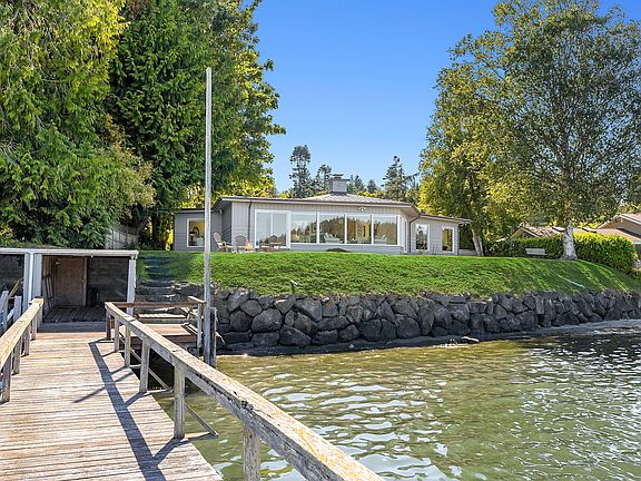 100' of private sandy beachfront with a boathouse and recreational dock!