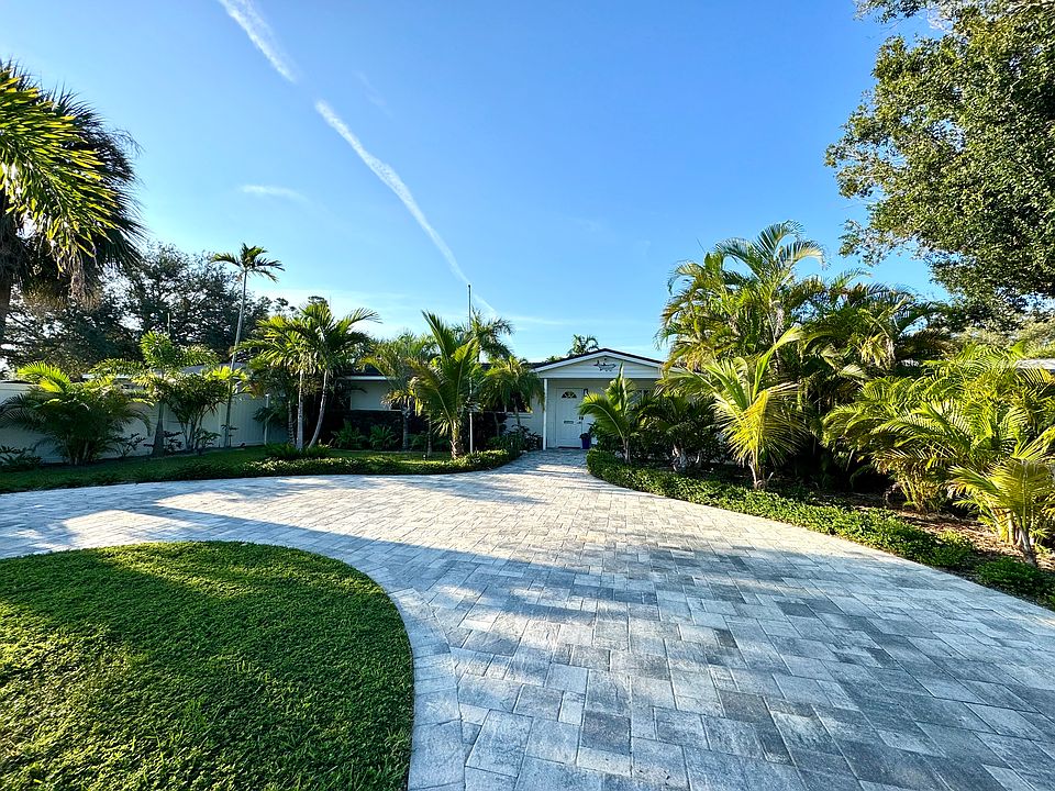 Large paver driveway in front of house