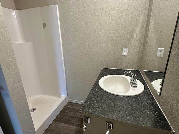 Bathroom with stand up shower and washer/dryer