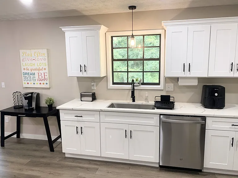 Spacious kitchen with dishwasher, large sink with coffee bar.