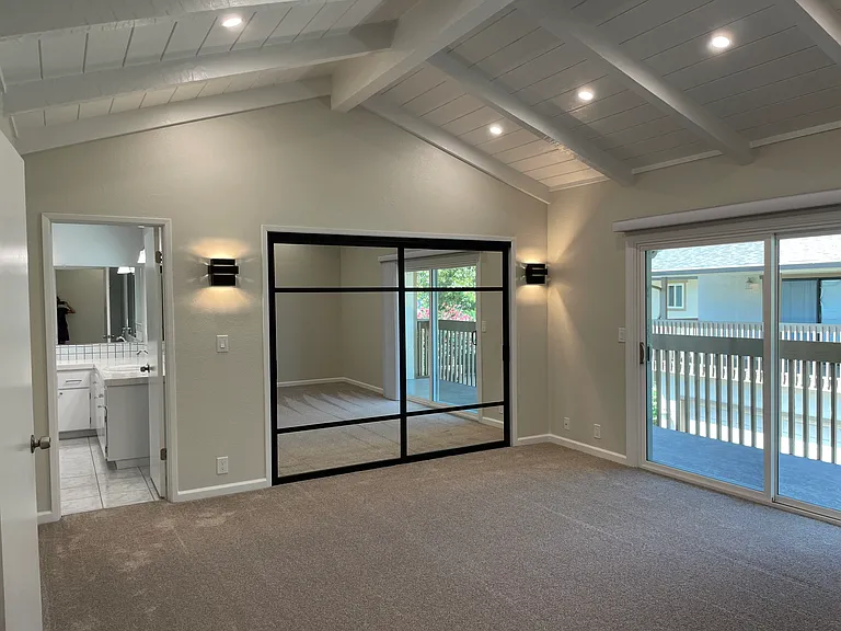 New closet doors, sconces, and balcony off master bedroom